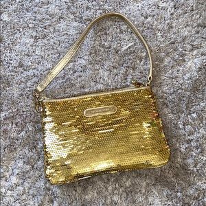 Micheal Kora gold sequin wristlet